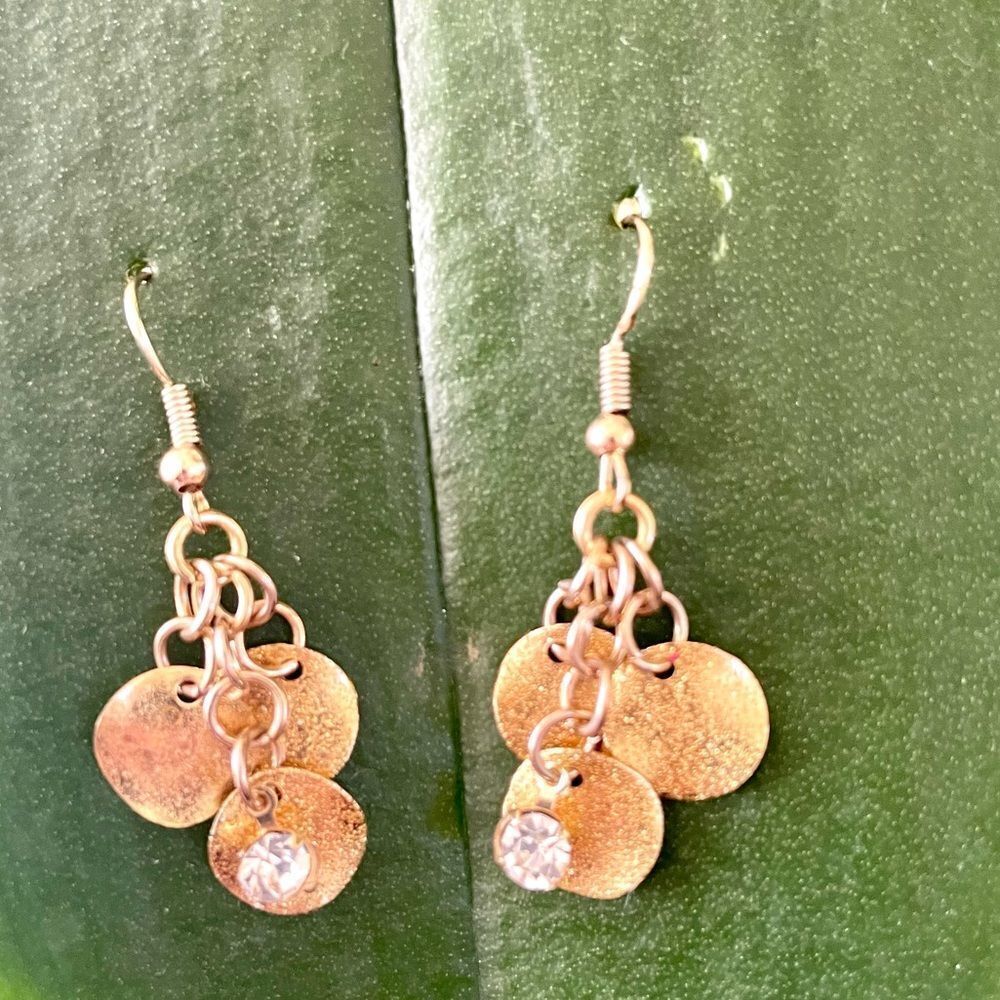 Gold tone disc dangling earrings with rhinestones